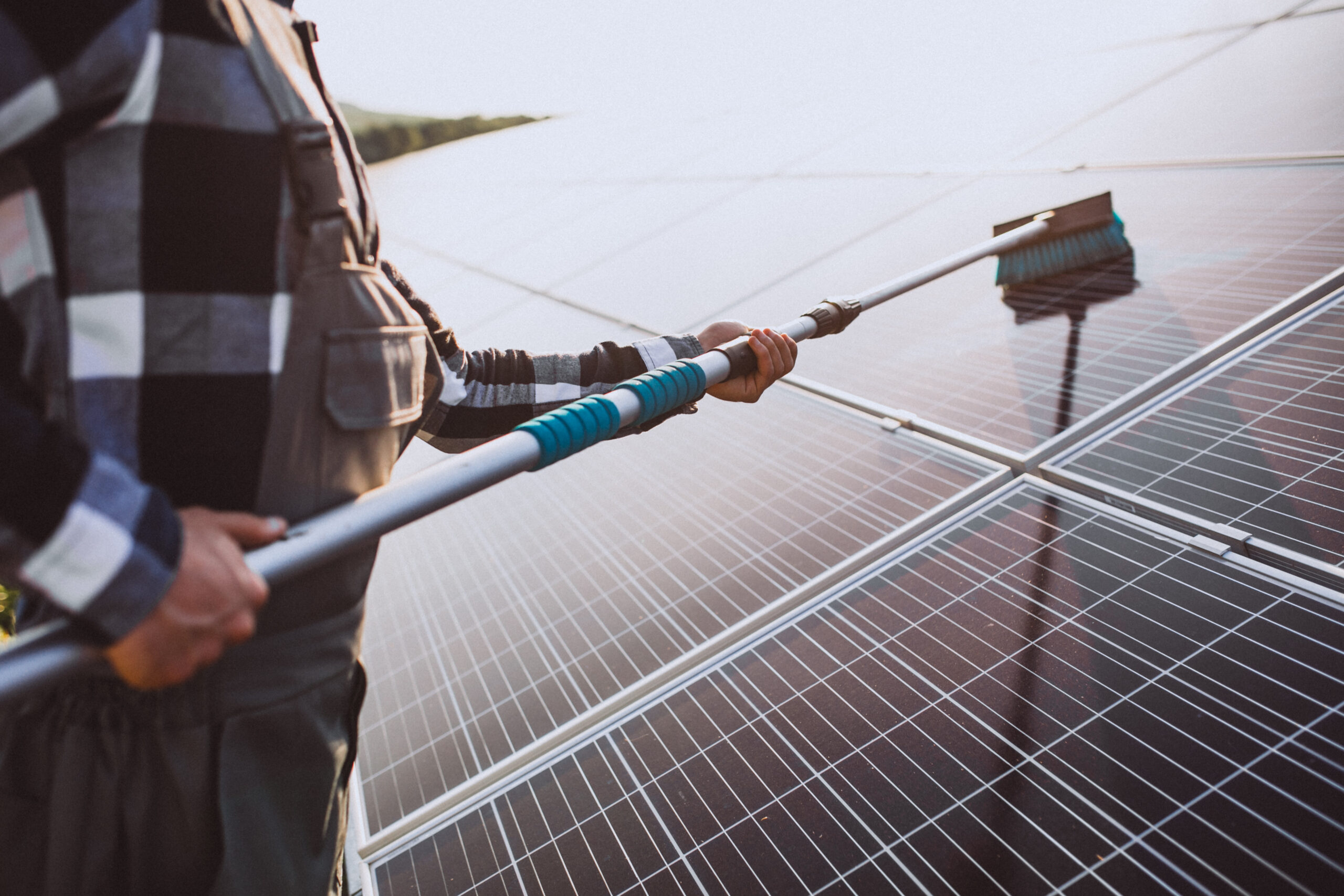 Man worker in the firld by the solar panels